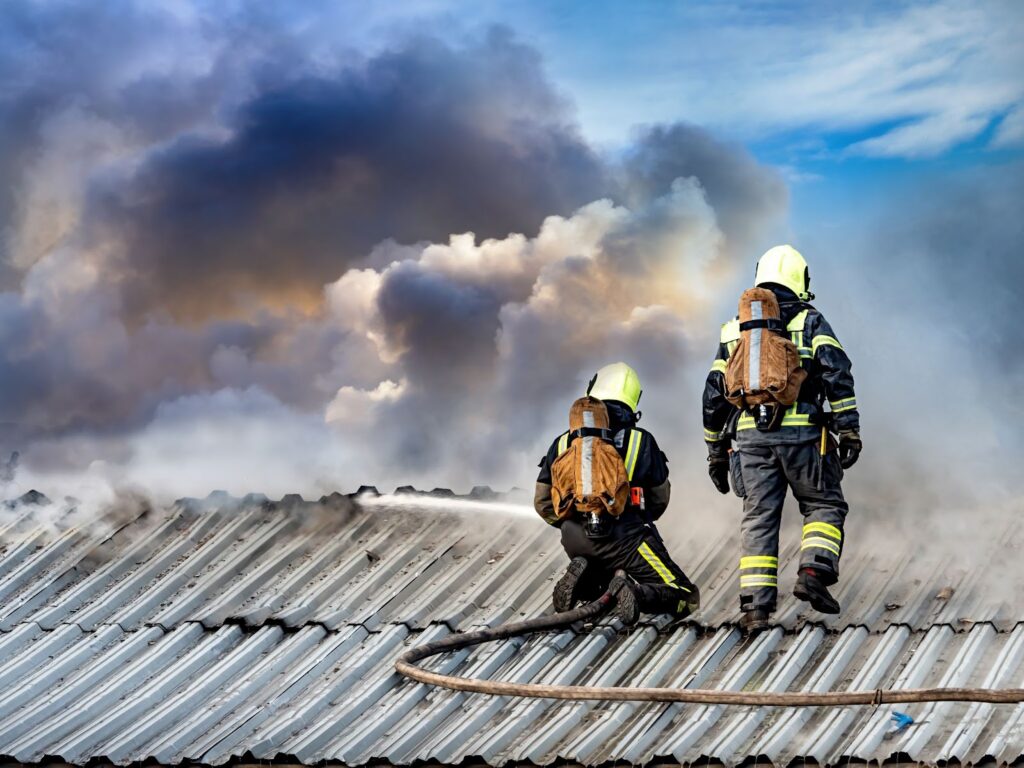 Emergency Firefighters extinguish the flame on the roof of the building