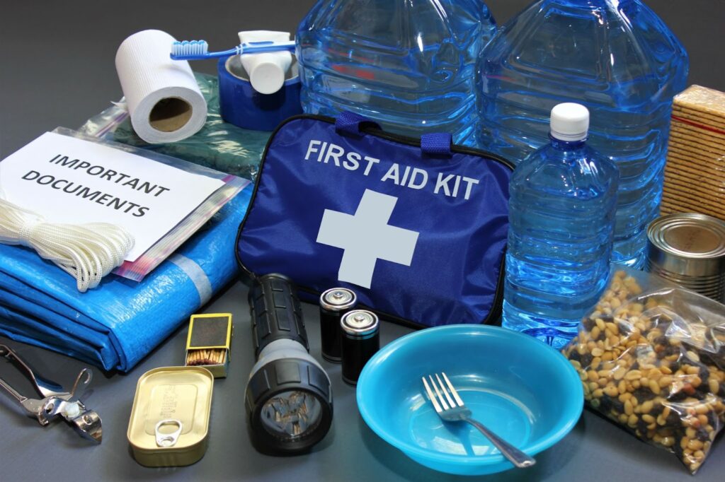 First aid kit with water, food, and other items for disaster preparedness, ensuring readiness for unforeseen events.